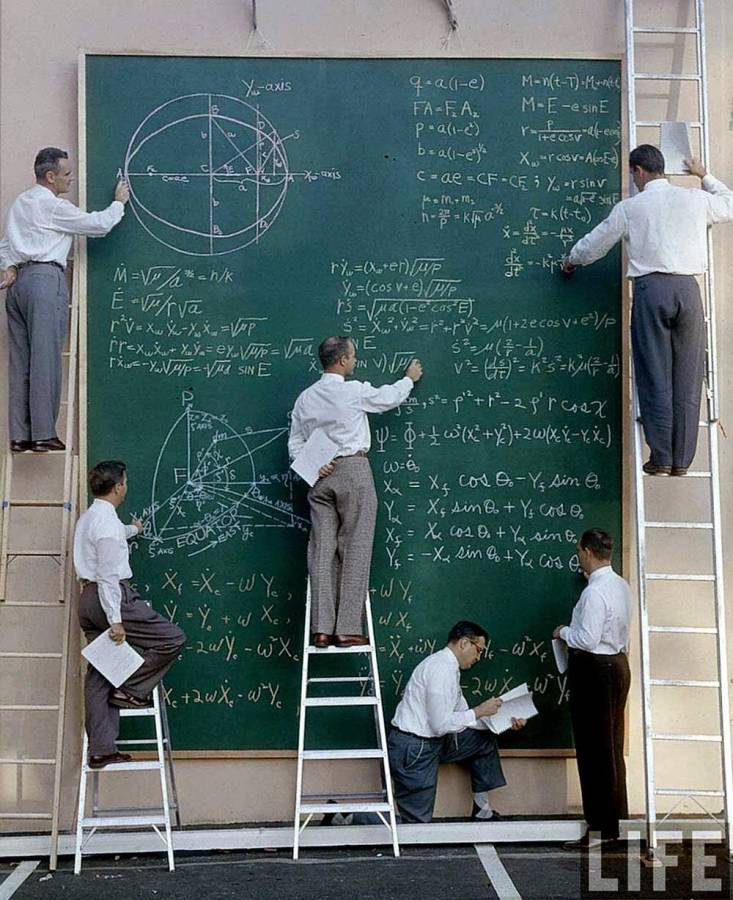 Attached picture scientists with their board of calculations,.jpg